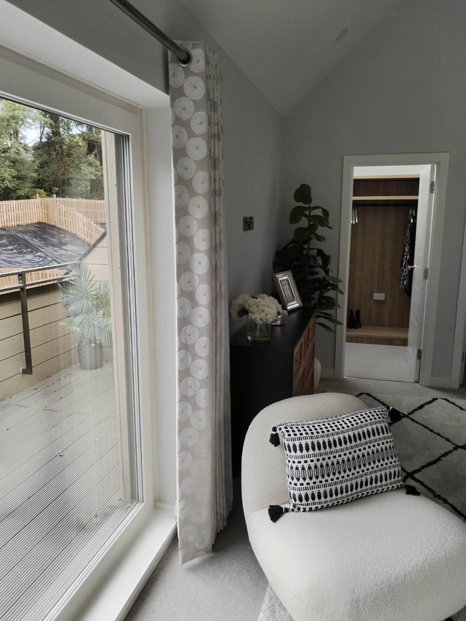 Finished living room with fitted curtains